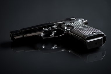 handgun on black background clipart