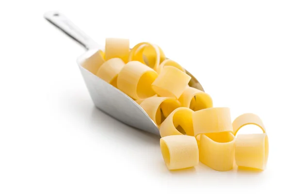 Uncooked pasta calamarata in metal scoop — Stock Photo, Image