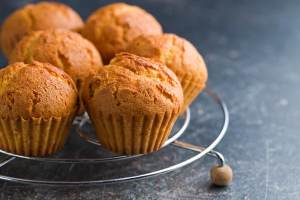 Sweet muffins on kitchen table — Stock Photo, Image