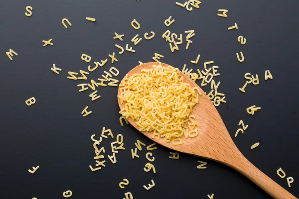 Alphabet pasta in spoon — Stock Photo, Image
