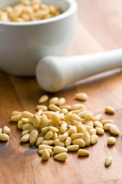 Pine nuts on wooden table — Stock Photo, Image