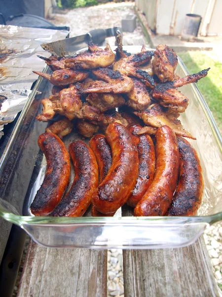 Chicken and sausage cooked on a grill — Stock Photo, Image