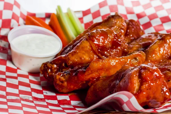 Chicken wings served with american fried sauce, celery and carrot