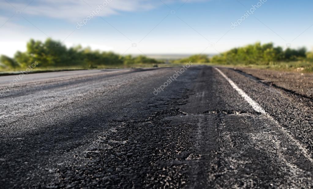 Bad asphalt road — Stock Photo © ssuaphoto 82687864
