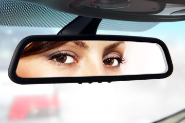 driver looks to rear-view mirror clipart