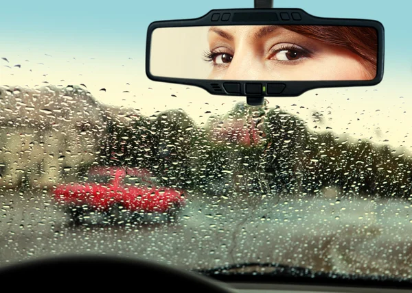 Driver looks to rearview mirror — Stock Photo, Image