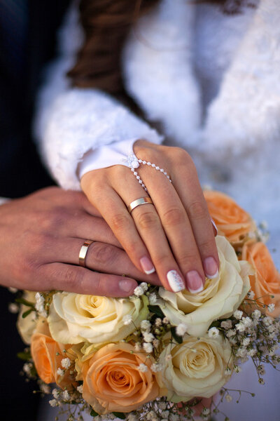 Couple's hands with wedding rings