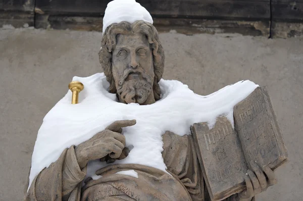 Snowy statue of Saint — Stock Photo, Image