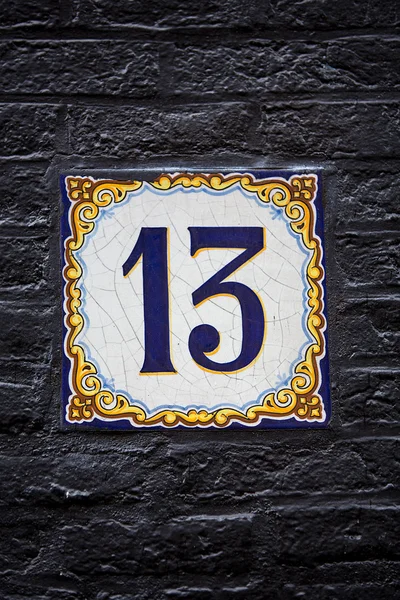 Decorative delftware tile with the number 13 — Stock Photo, Image