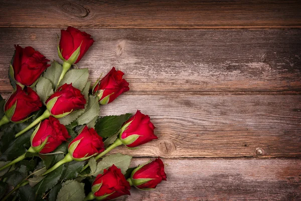 Red roses on old wood Royalty Free Stock Photos