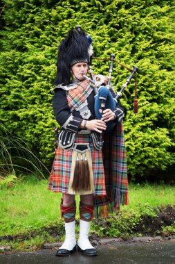 Scottish piper plays the Bagpipes