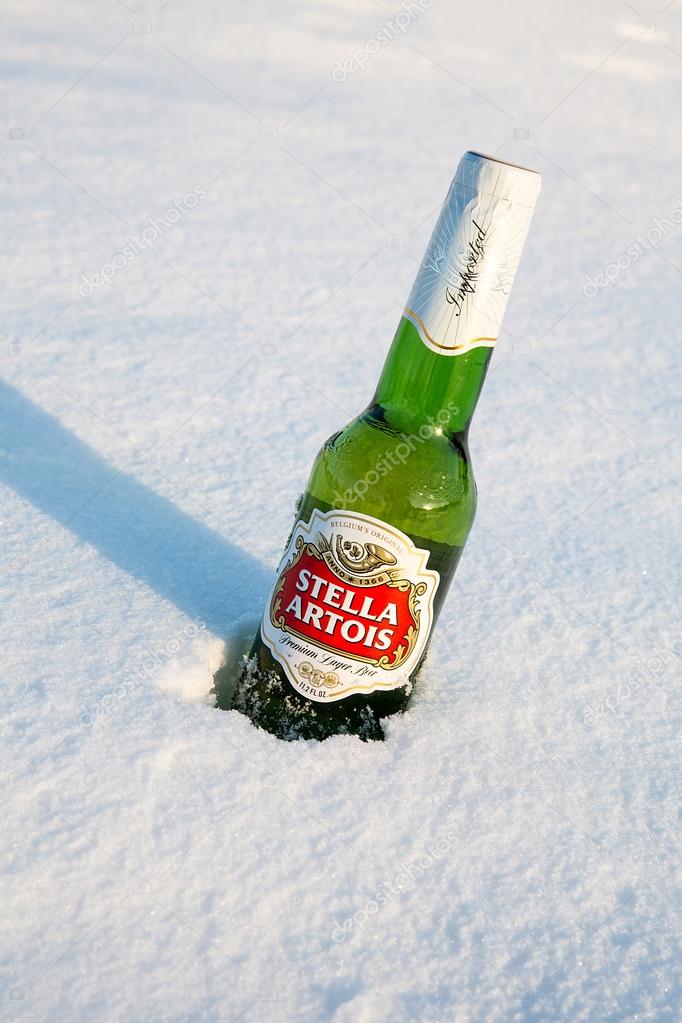 MONTREAL, CANADA - January 21, 2015: A bottle of Stella Artois beer cools in the winter snow. A European pilsner beer, very popular in Canada. Montreal