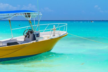 Yellow boat on the coast of Caribbean Sea clipart