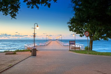 Wooden pier in Gdynia Orlowo at sunrise clipart