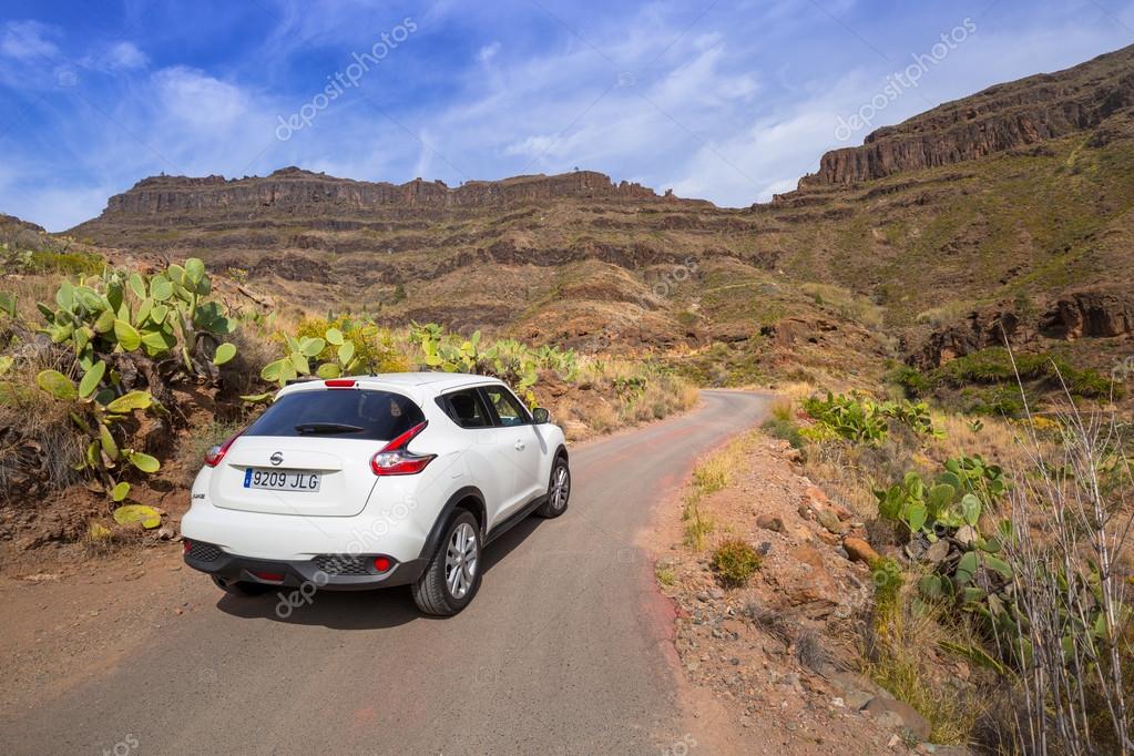 GRAN CANARIA, SPAIN - APRIL 21, 2016: White Nissan Juke in the mountain scenery of Canaries. The Nissan Juke is a mini sport utility vehicle (SUV) produced by the Japanese manufacturer Nissan.