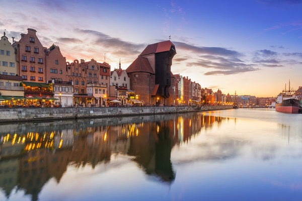 Old town of Gdansk with reflection in Motlawa river at sunset