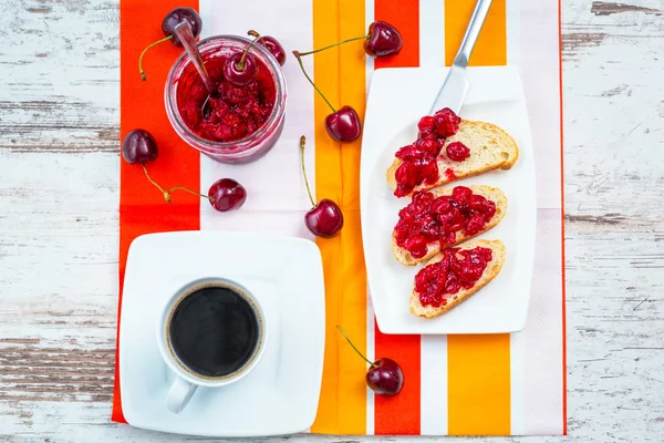 Sandwiches with cherry jam and coffee — Stock Photo, Image