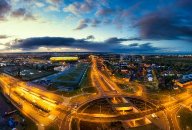 Gdansk, Poland - 19 October, 2020: Aerial landscape with amber shape Energa Stadium in Gdansk at dusk, Poland. clipart