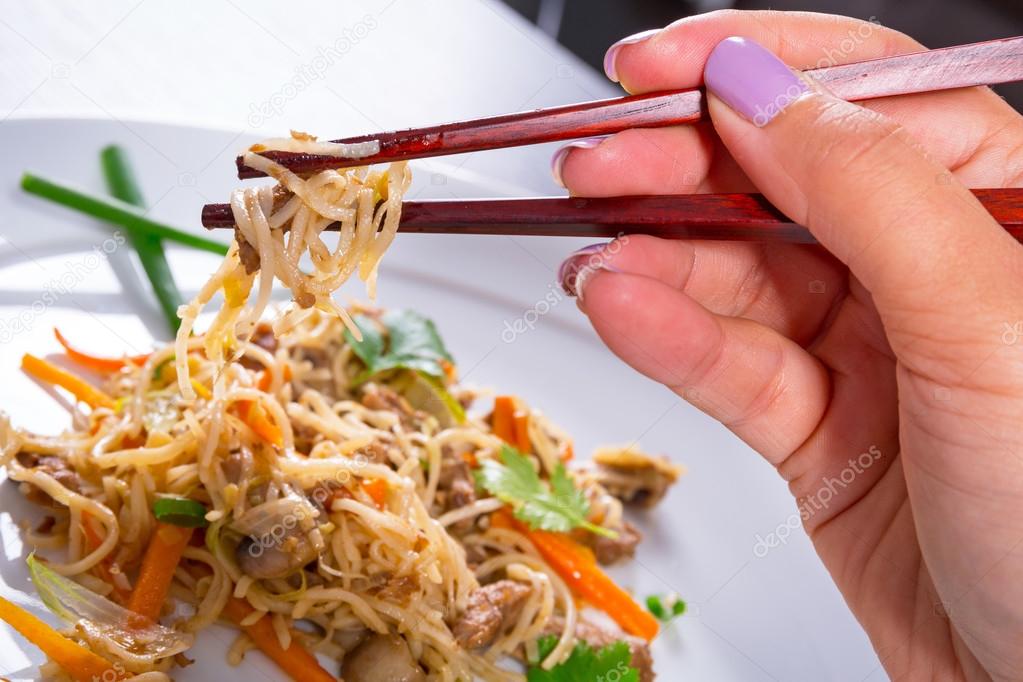 Eating chinese noodles