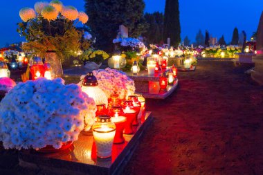 Colorful candles on the cemetery at All Saints Day clipart