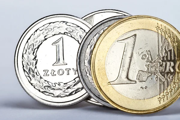 One euro and one zloty coin exchange — Stock Photo, Image
