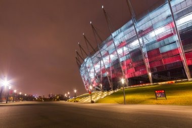 National Stadium in Warsaw illuminated at night clipart