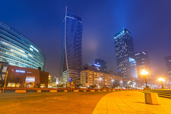 WARSAW, POLAND - 28 FEBRUARY 2014: Skyscrapers in the city center of Warsaw at night, Poland. Warsaw is the capital and largest city of Poland with population estimated at 1,8 million residents.