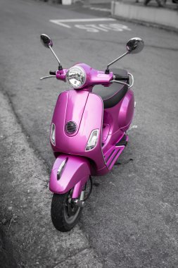 Pink italian scooter on the street clipart