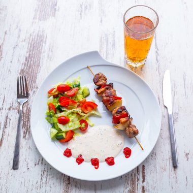 Grilled duck shashlik with salad