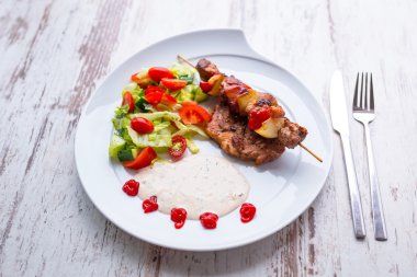 Grilled duck shashlik with salad