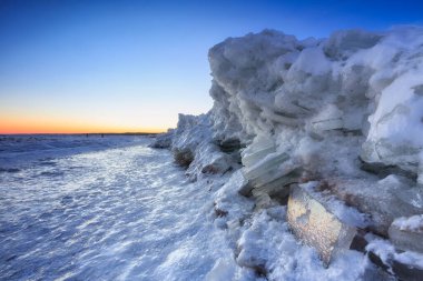 Ice toros on the Baltic Sea beach in Mikoszewo at sunrise. Poland