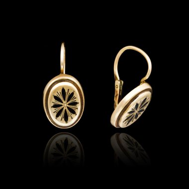 Gold earrings isolated on black background  clipart