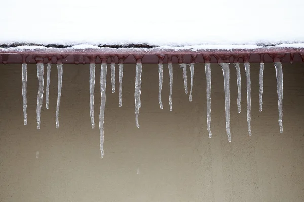 Eiszapfen, die von einem Dach herabhängen — Stockfoto