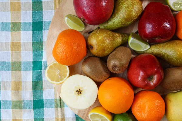 Pile of fresh fruit on colored kitchen towel — Stock Photo, Image