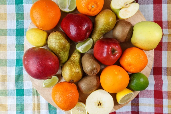 Fresh fruit on colored kitchen towel — Stock Photo, Image