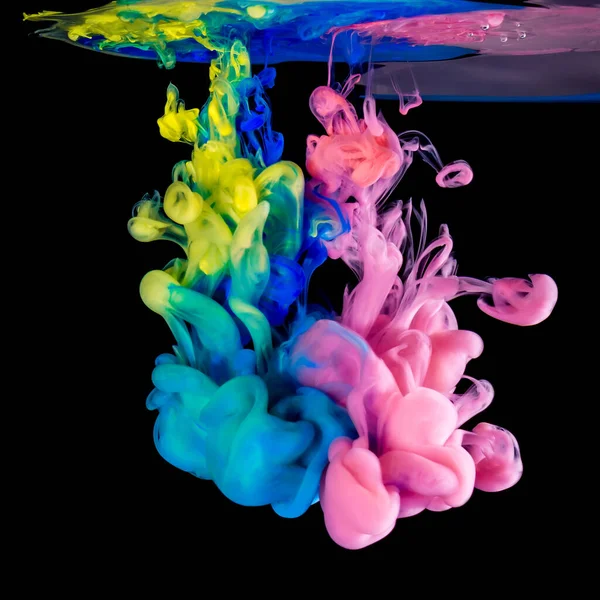 Colored inks in water on black background — Stock Photo, Image