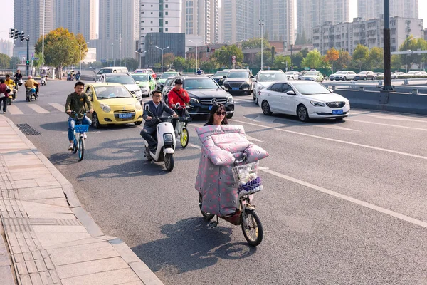 Άνθρωποι με ηλεκτρικό ποδήλατο με πολύχρωμο παρμπρίζ σε σταυροδρόμι, Hefei, Κίνα. — Φωτογραφία Αρχείου
