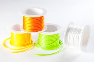 spools of ribbon on white background clipart