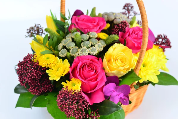 Красивые цветы в плетеной корзине на светлом фоне — стоковое фото