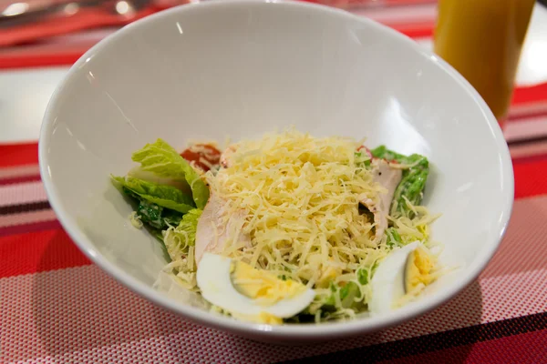 Caesar salad on table in restaurant — Stock Photo, Image