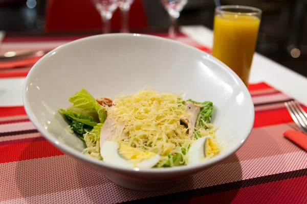 Caesar salad on table in restaurant — Stock Photo, Image