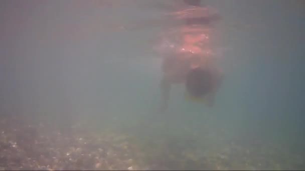 Teenager floats under water in sea — Stock Video