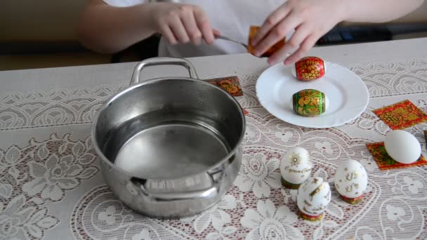 Boy sticks stickers on  Easter eggs — Stock Video