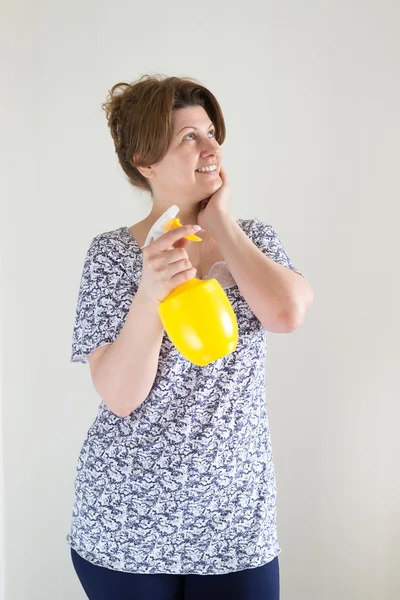 Woman with bottle for watering flowers in  hands — Stock Photo, Image
