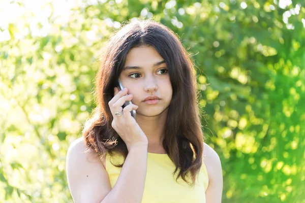 Ragazza triste che parla al telefono nel parco — Foto Stock