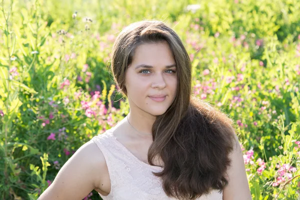 Portrait of girl of 16 years in flower meadow — Stock Photo, Image