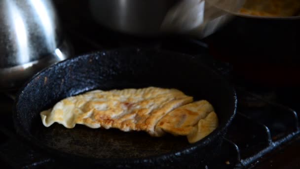 Домогосподарка жарке кухарі виносять чебуреки сковороді - Грузинська Національна страва — стокове відео