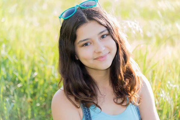 Portrait of positive teen girl outdoors in summer — Stock Photo, Image