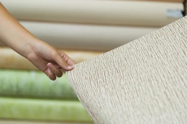 Teen buyer holding a beige wallpaper — Stock Photo, Image