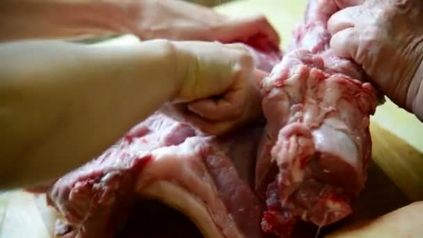 Женщины режут большой кусок свинины — стоковое видео